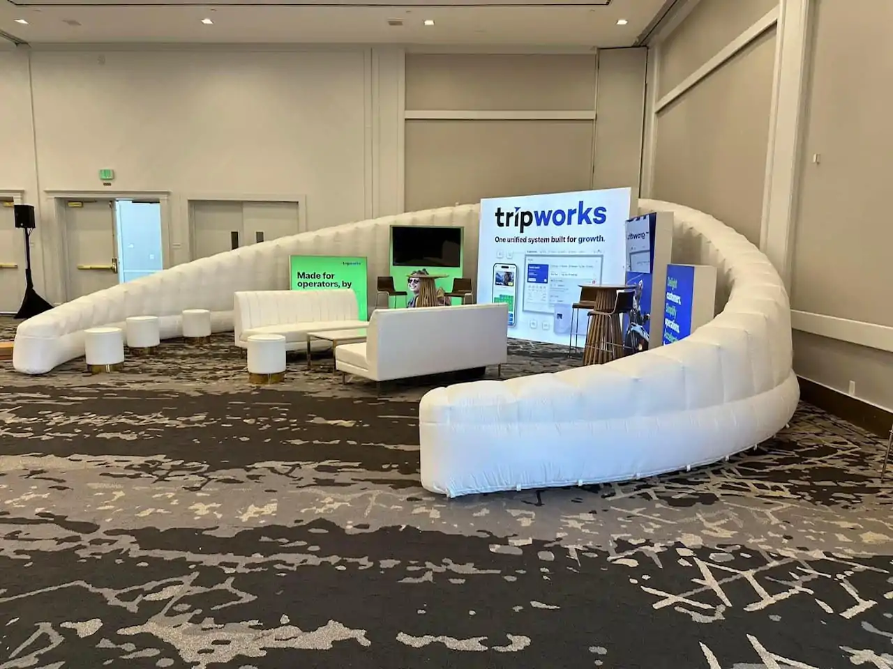 Conference booth with seating and displays.