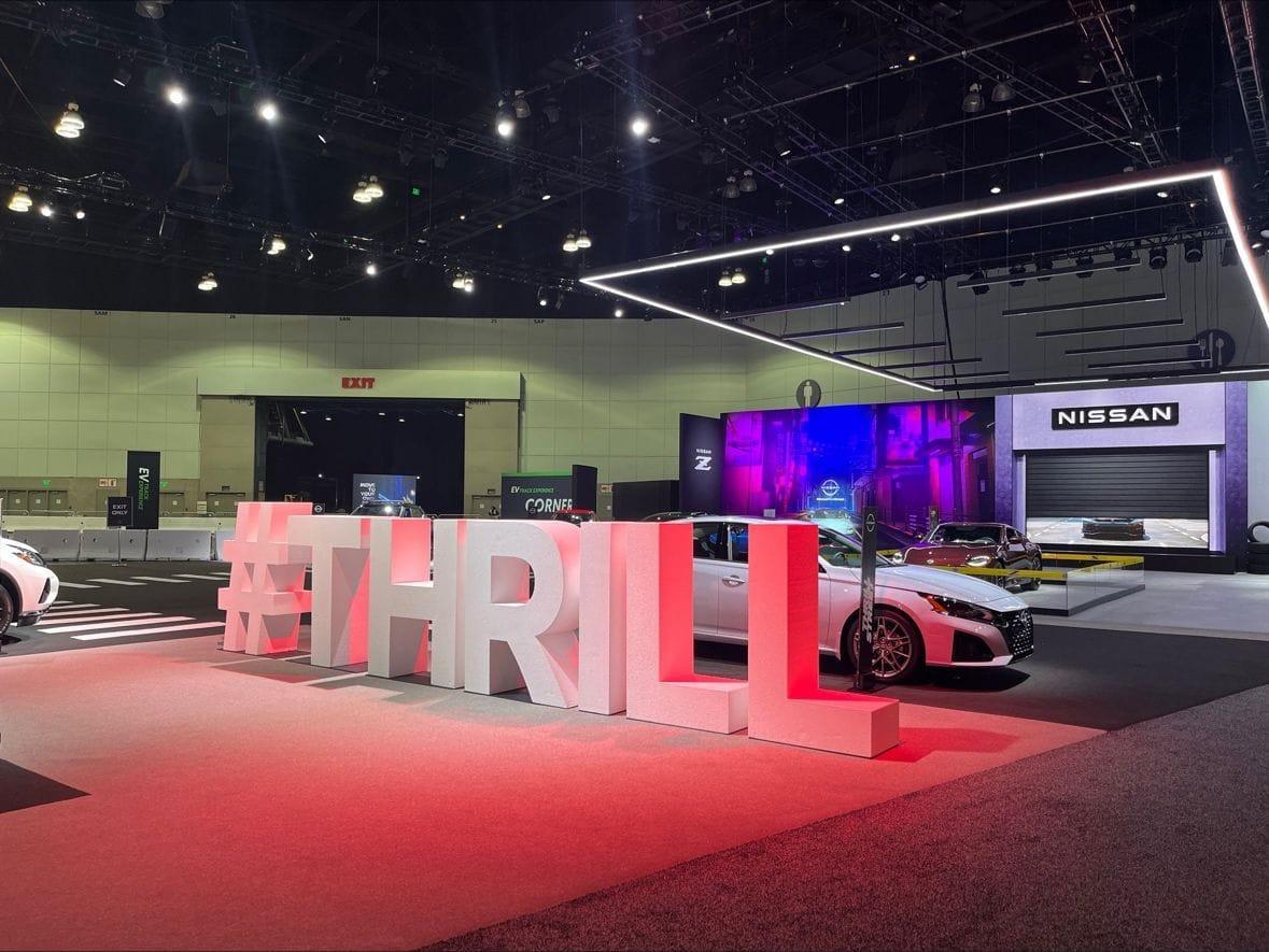 Large #THRILL sign at Nissan car exhibit