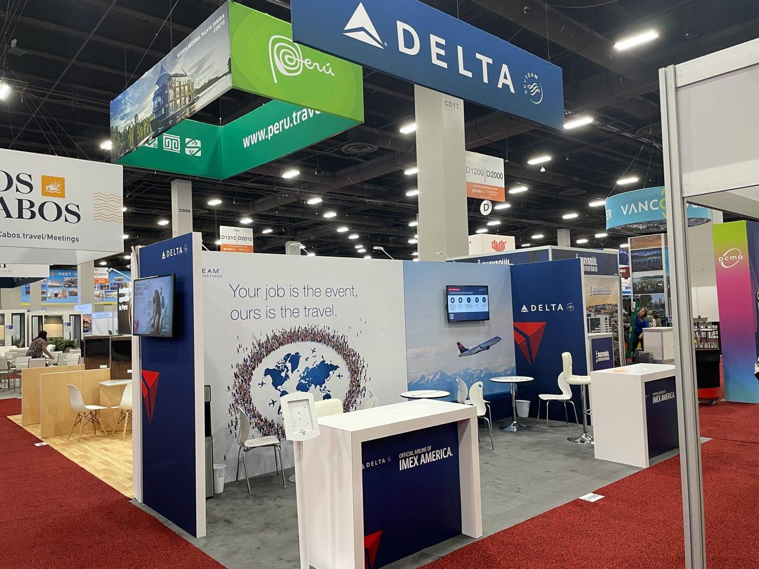 Delta Airlines booth at a travel expo with informational displays and seating.