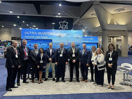 Group of people at Ultra Maritime booth.