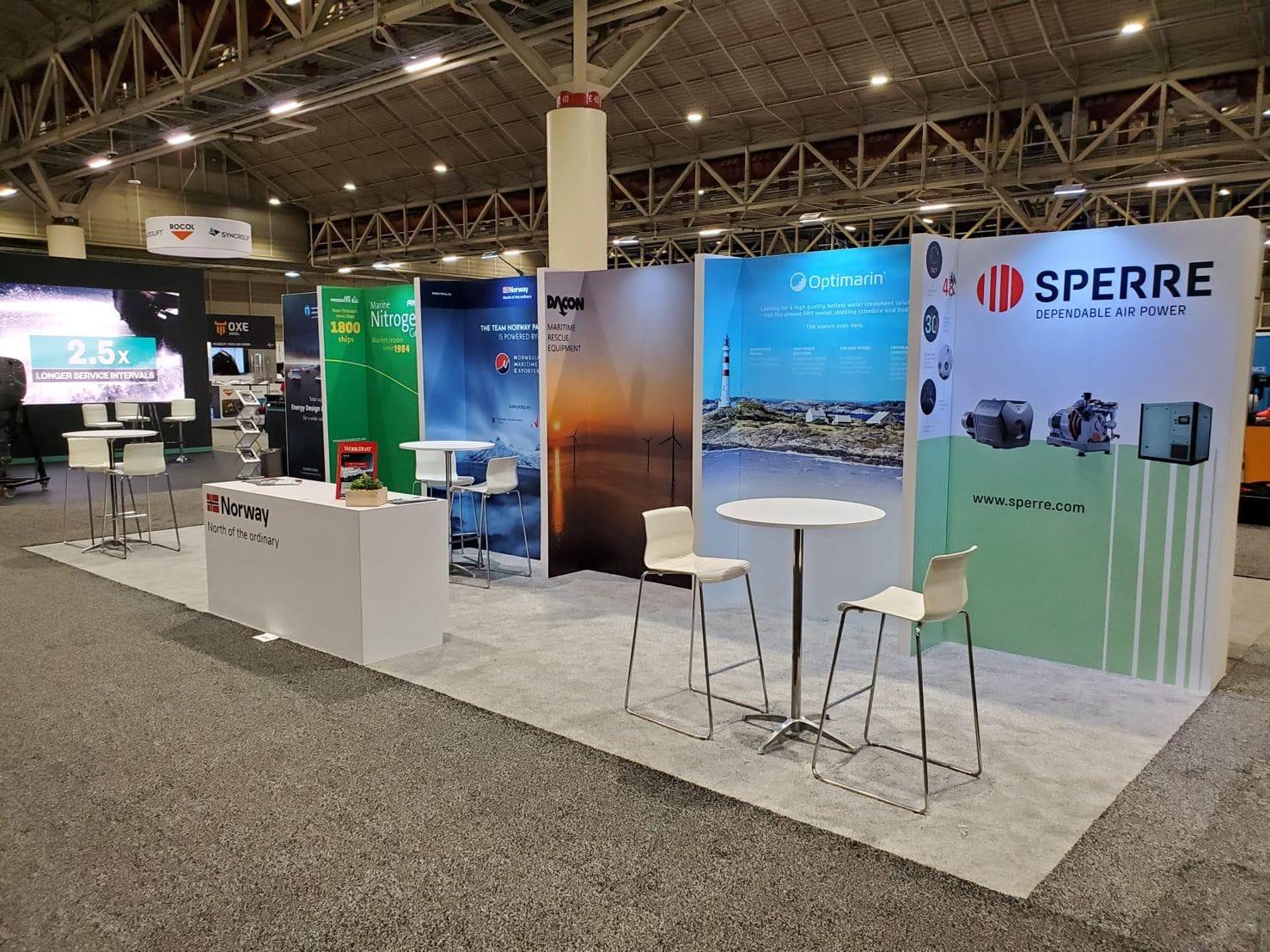 Empty exhibition booth with tables and chairs